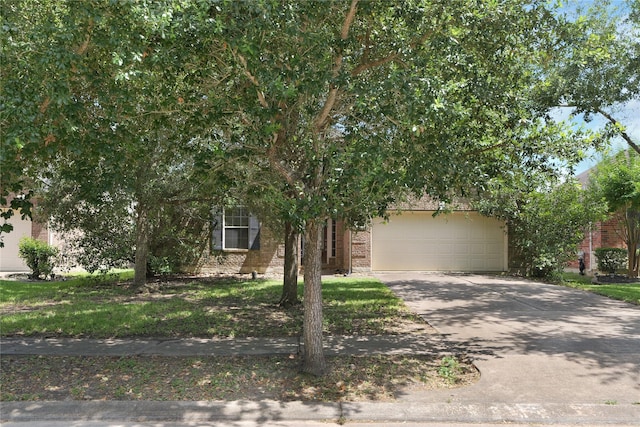 13406 Georgia Hollow Ct, Rosharon, TX 77583 - view of property hidden behind natural elements featuring brick siding, driveway, and a garage