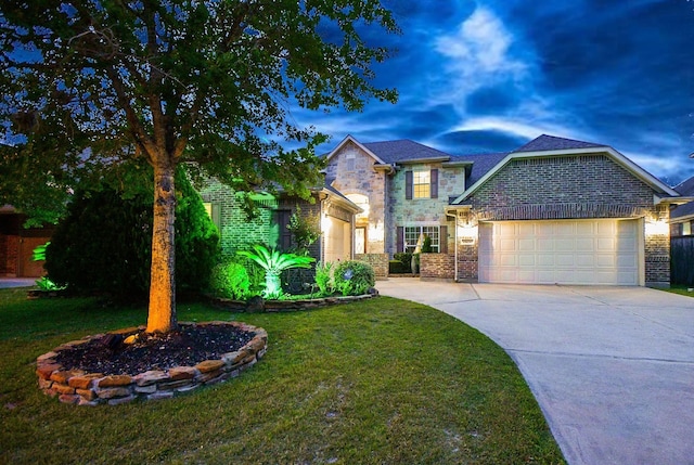 28030 Sugarside Glen Dr, Katy, TX 77494 - view of front facade with a garage, concrete driveway, a front yard, stone siding, and brick siding