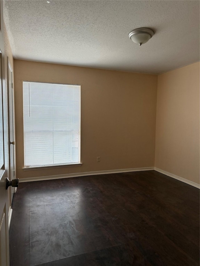9350 Country Creek Dr Unit 1, Houston, TX 77036 - empty room featuring a textured ceiling and baseboards