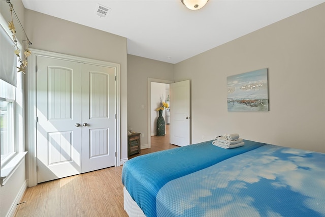 839 S Monkhouse Dr, Crystal Beach, TX 77650 - bedroom with light wood-style floors, a closet, and baseboards