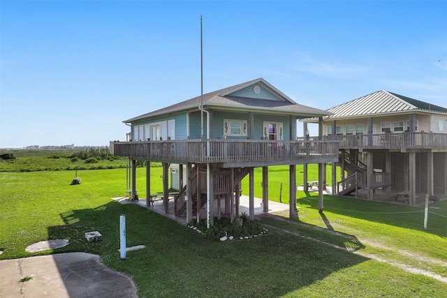 839 S Monkhouse Dr, Crystal Beach, TX 77650 - rear view of property featuring stairs, a patio area, a yard, a wooden deck, and a carport