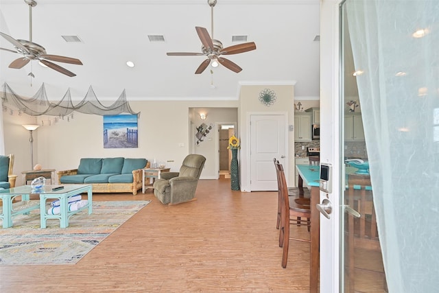839 S Monkhouse Dr, Crystal Beach, TX 77650 - living room with ceiling fan, ornamental molding, light wood-style flooring, and baseboards