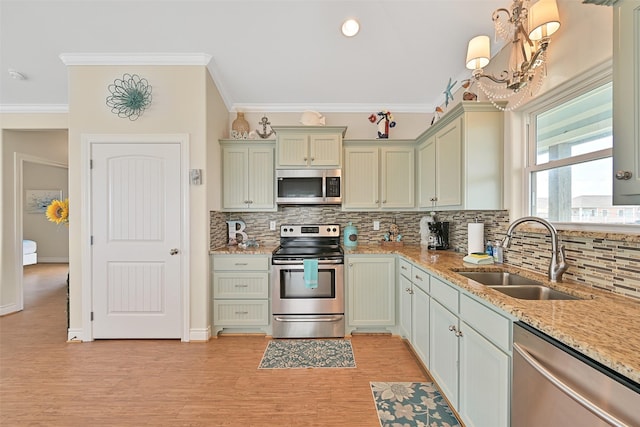 839 S Monkhouse Dr, Crystal Beach, TX 77650 - kitchen with stainless steel appliances, a sink, backsplash, crown molding, and light stone countertops