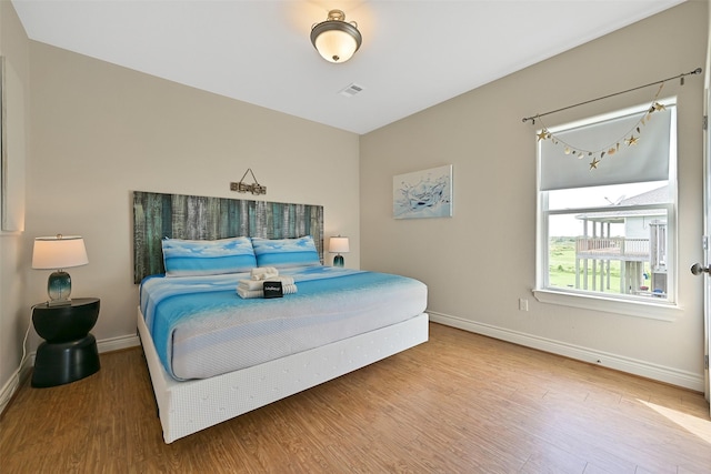 839 S Monkhouse Dr, Crystal Beach, TX 77650 - bedroom featuring baseboards and wood finished floors