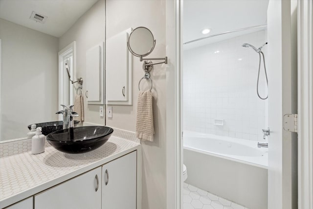 646 Lester St, Houston, TX 77007 - full bath with vanity, shower / bath combination, toilet, tile patterned flooring, and recessed lighting