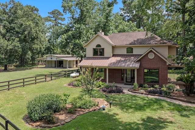 6221 Ranch Lake Dr, Magnolia, TX 77354 - view of front facade with a standing seam roof, brick siding, covered porch, metal roof, and a shingled roof