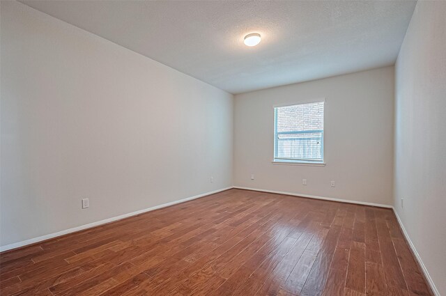 3934 Medici Ct, Missouri City, TX 77459 - spare room featuring wood finished floors and baseboards