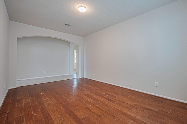3934 Medici Ct, Missouri City, TX 77459 - spare room with wood finished floors, arched walkways, and baseboards