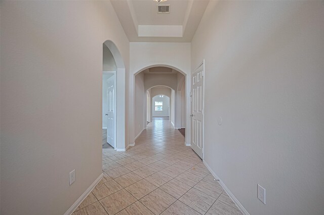 3934 Medici Ct, Missouri City, TX 77459 - hall with arched walkways, light tile patterned flooring, and baseboards