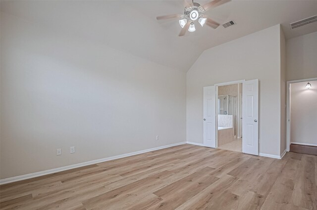 3934 Medici Ct, Missouri City, TX 77459 - unfurnished bedroom with light wood-style flooring, baseboards, ensuite bath, and high vaulted ceiling