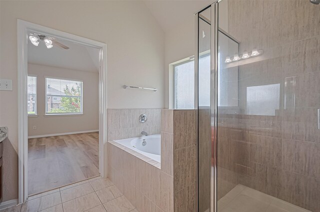 3934 Medici Ct, Missouri City, TX 77459 - bathroom with a bath, a stall shower, tile patterned flooring, vaulted ceiling, and ceiling fan