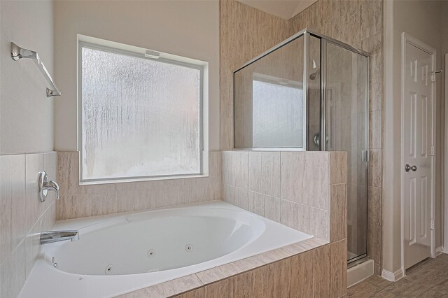 3934 Medici Ct, Missouri City, TX 77459 - bathroom with plenty of natural light, a stall shower, and a whirlpool tub