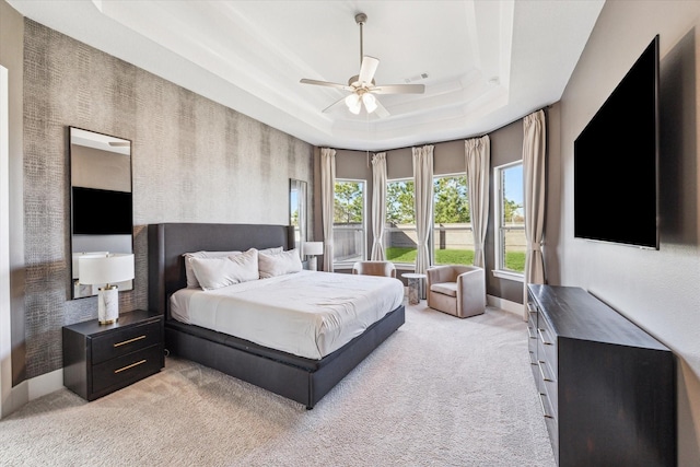 11207 Cosmopolitan Dr, Cypress, TX 77433 - bedroom featuring light colored carpet, a raised ceiling, baseboards, and ceiling fan