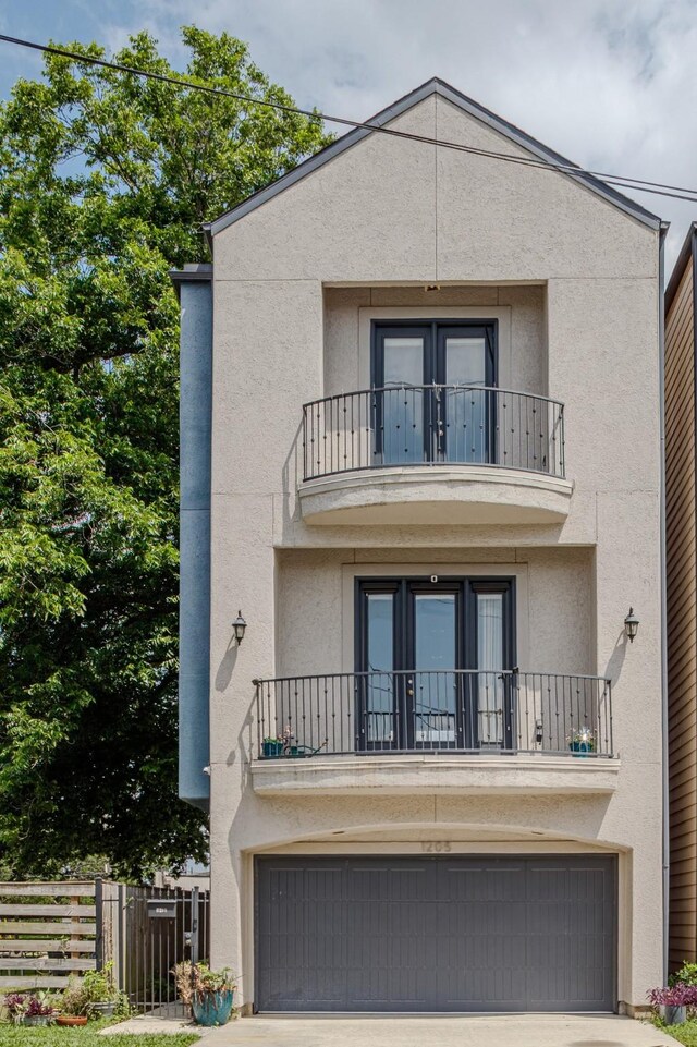 1205 Sampson St, Houston, TX 77003 - front of property with a balcony, an attached garage, and concrete driveway
