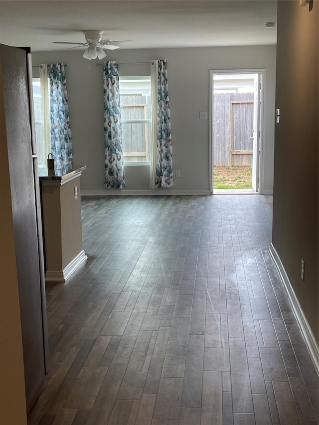 15508 Taylorcrest Dr, Conroe, TX 77306 - unfurnished living room featuring ceiling fan, dark wood-style flooring, and baseboards