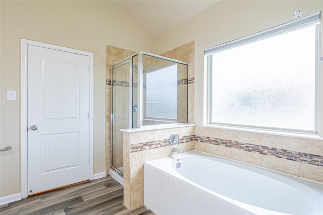 8138 Heartbrook Field Ln, Cypress, TX 77433 - bathroom featuring a garden tub, a stall shower, wood finished floors, and lofted ceiling