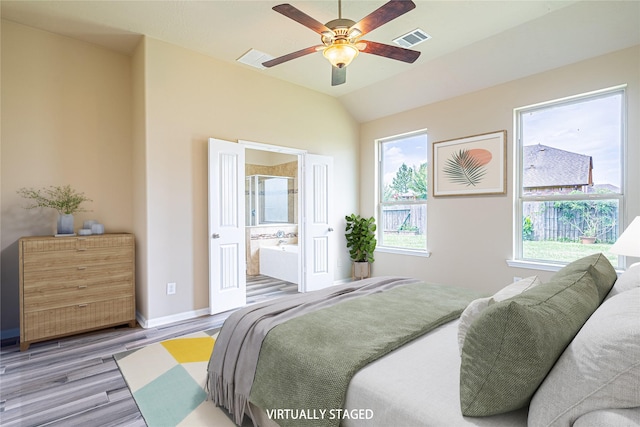 8138 Heartbrook Field Ln, Cypress, TX 77433 - bedroom featuring wood finished floors, connected bathroom, lofted ceiling, and ceiling fan