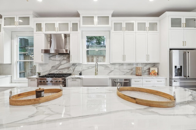 412 Hawthorne St, Houston, TX 77006 - kitchen with wall chimney exhaust hood, a sink, stainless steel appliances, tasteful backsplash, and recessed lighting