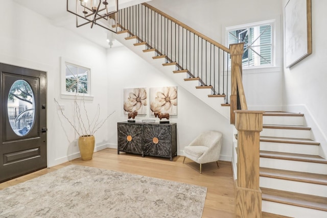 412 Hawthorne St, Houston, TX 77006 - foyer entrance featuring wood finished floors, stairs, a chandelier, and baseboards