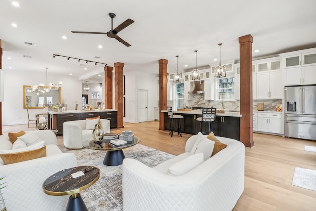 412 Hawthorne St, Houston, TX 77006 - living area featuring ornate columns, light wood finished floors, recessed lighting, ceiling fan, and baseboards