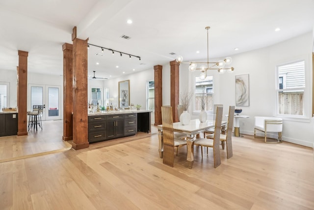 412 Hawthorne St, Houston, TX 77006 - dining space with decorative columns, light wood finished floors, rail lighting, a chandelier, and recessed lighting