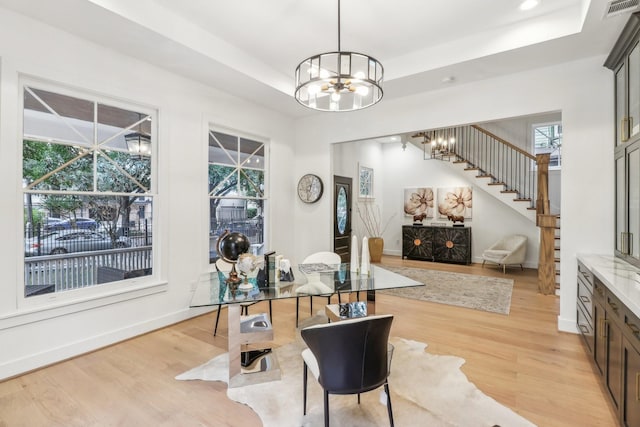 412 Hawthorne St, Houston, TX 77006 - dining room with a chandelier, light wood finished floors, a raised ceiling, plenty of natural light, and recessed lighting