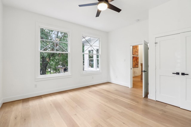 412 Hawthorne St, Houston, TX 77006 - unfurnished bedroom featuring multiple windows, light wood-style flooring, and baseboards