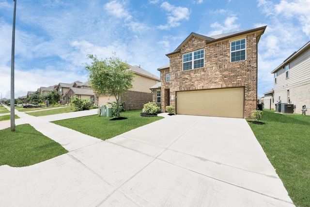 24810 Puccini Pl, Katy, TX 77493 - view of front of home featuring a garage, driveway, a front yard, and brick siding
