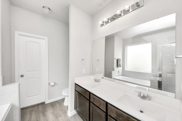 24810 Puccini Pl, Katy, TX 77493 - bathroom with a garden tub, double vanity, wood finished floors, and a shower stall