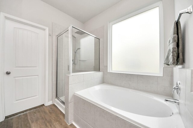 24810 Puccini Pl, Katy, TX 77493 - bathroom featuring a bath, a shower stall, and wood finished floors