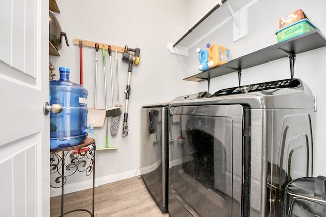 24810 Puccini Pl, Katy, TX 77493 - washroom featuring washer and dryer, baseboards, and wood finished floors