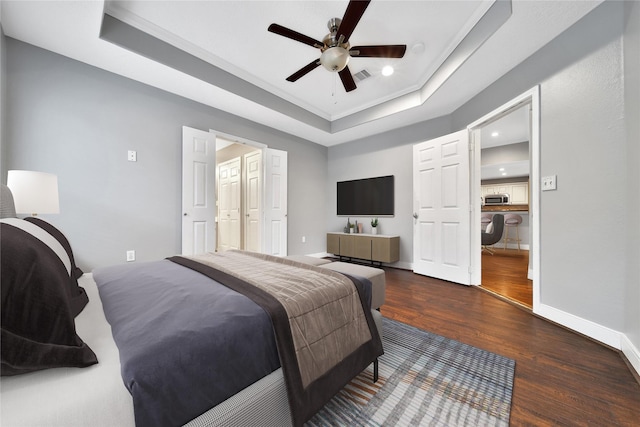 720 Springwood Dr, Conroe, TX 77385 - bedroom with a raised ceiling, wood finished floors, baseboards, recessed lighting, and crown molding