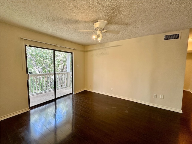 2750 Holly Hall St Unit 1215, Houston, TX 77054 - empty room featuring a ceiling fan, a textured ceiling, dark wood-style floors, and baseboards