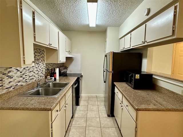 2750 Holly Hall St Unit 1215, Houston, TX 77054 - kitchen with a sink, appliances with stainless steel finishes, a textured ceiling, backsplash, and light tile patterned flooring