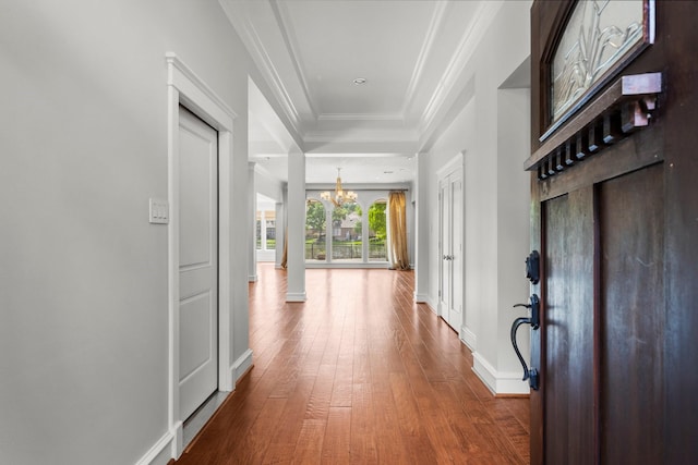 44 Vinebrook Rd, The Woodlands, TX 77380 - entryway with a chandelier, wood-type flooring, baseboards, and crown molding