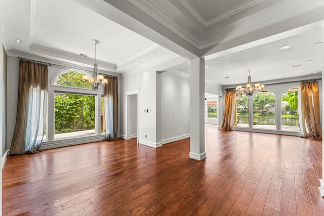 44 Vinebrook Rd, The Woodlands, TX 77380 - unfurnished living room with a chandelier, dark wood-style flooring, baseboards, and ornamental molding