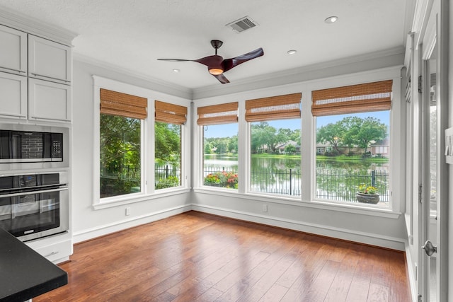44 Vinebrook Rd, The Woodlands, TX 77380 - unfurnished sunroom with a water view