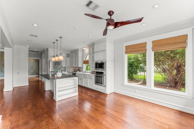 44 Vinebrook Rd, The Woodlands, TX 77380 - kitchen featuring stainless steel appliances, ceiling fan, healthy amount of natural light, a sink, and crown molding