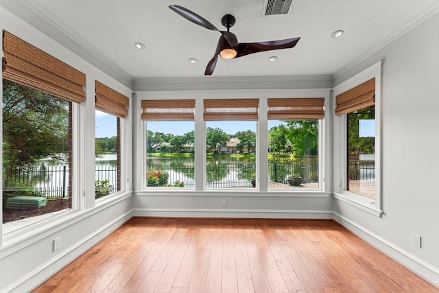 44 Vinebrook Rd, The Woodlands, TX 77380 - unfurnished sunroom featuring ornamental molding, wood-type flooring, baseboards, and a water view