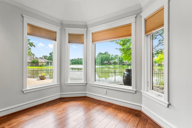 44 Vinebrook Rd, The Woodlands, TX 77380 - unfurnished sunroom with ornamental molding, hardwood / wood-style floors, a water view, and baseboards