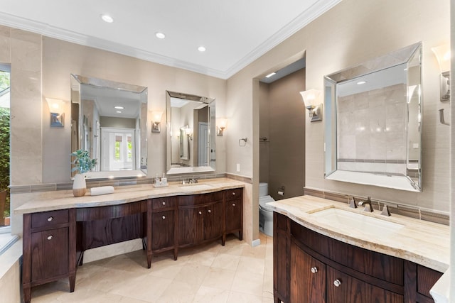 44 Vinebrook Rd, The Woodlands, TX 77380 - full bath with two vanities, ornamental molding, toilet, and recessed lighting
