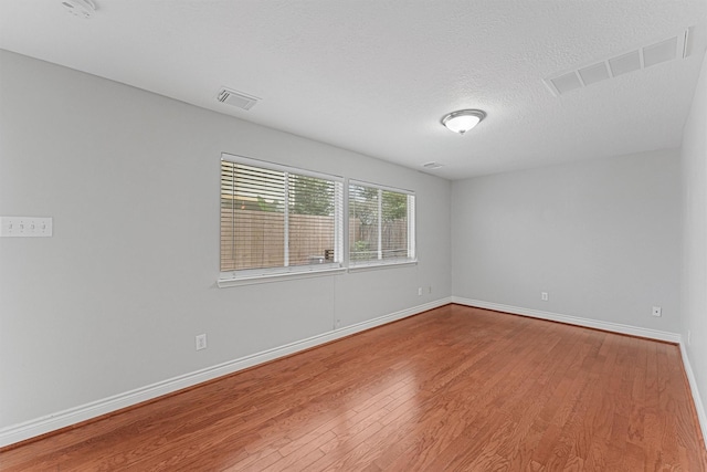 1646 W 13th St, Houston, TX 77008 - unfurnished room featuring wood finished floors, baseboards, and a textured ceiling