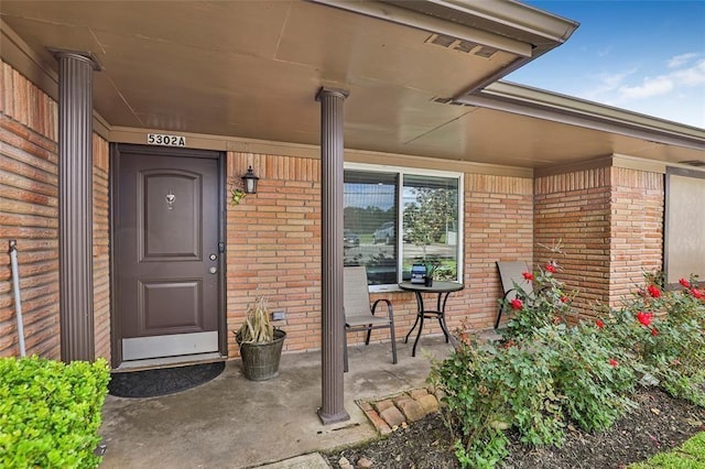 5302 Treaschwig Rd, Spring, TX 77373 - doorway to property with brick siding and a porch