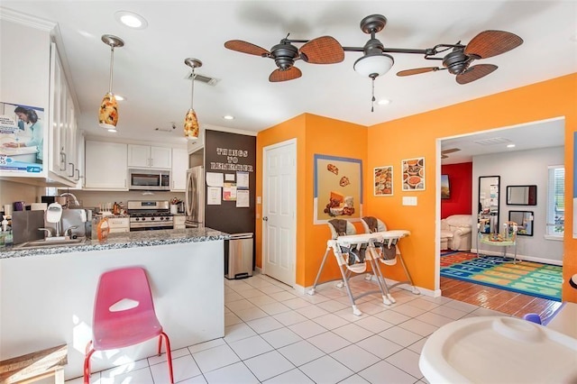 5302 Treaschwig Rd, Spring, TX 77373 - kitchen featuring appliances with stainless steel finishes, a ceiling fan, white cabinets, baseboards, and recessed lighting