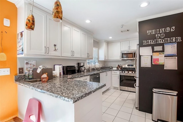 5302 Treaschwig Rd, Spring, TX 77373 - kitchen with stainless steel appliances, a peninsula, a sink, white cabinets, and recessed lighting