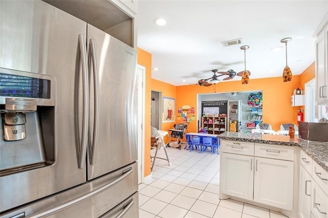 5302 Treaschwig Rd, Spring, TX 77373 - kitchen featuring stainless steel refrigerator with ice dispenser, light tile patterned flooring, a peninsula, white cabinetry, and decorative light fixtures