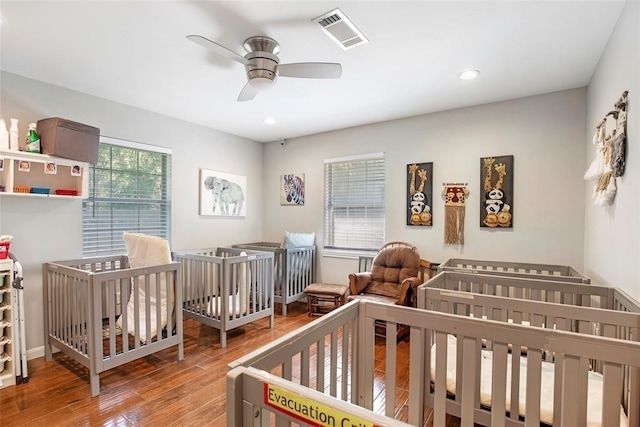 5302 Treaschwig Rd, Spring, TX 77373 - bedroom featuring wood finished floors, a ceiling fan, recessed lighting, and a crib