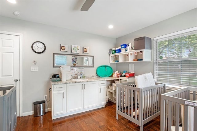 5302 Treaschwig Rd, Spring, TX 77373 - bedroom featuring a sink, dark wood-style flooring, a nursery area, recessed lighting, and baseboards