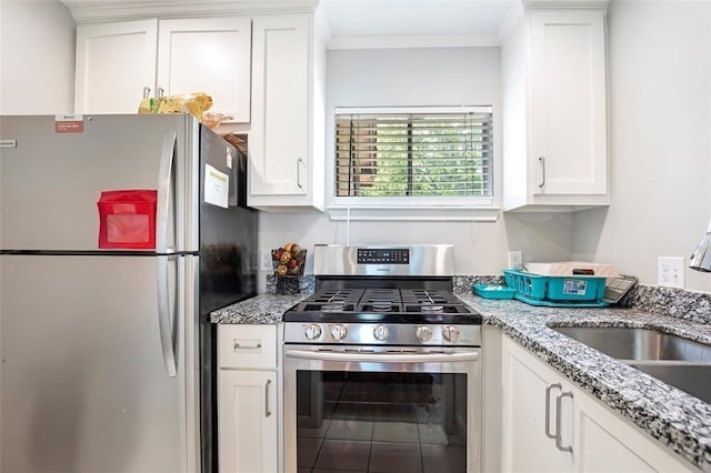 5302 Treaschwig Rd, Spring, TX 77373 - kitchen featuring appliances with stainless steel finishes, white cabinets, crown molding, a sink, and light stone counters