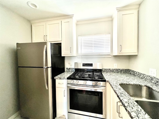5302 Treaschwig Rd, Spring, TX 77373 - kitchen with appliances with stainless steel finishes, light stone countertops, a sink, ornamental molding, and white cabinetry